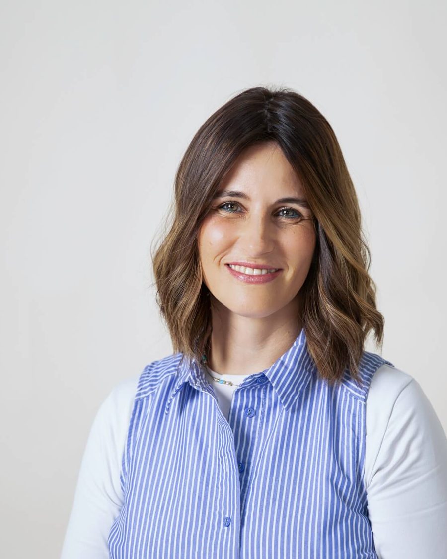 Chava Shmilovitch, smiling, in a blue striped blouse